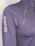 purple long-sleeve shirt with a brand logo on the sleeve against a white background showing details of the logo in a close up shot