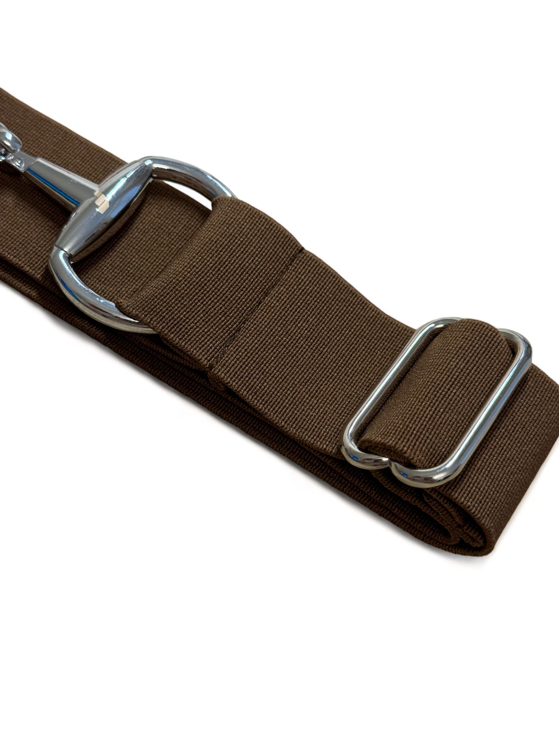 A chestnut-colored, adjustable belt with a silver-colored snaffle design and engraved hardware.